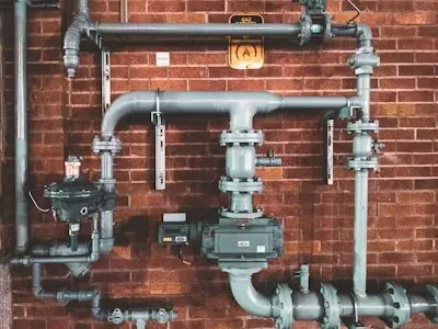 Plumber at work on pipework